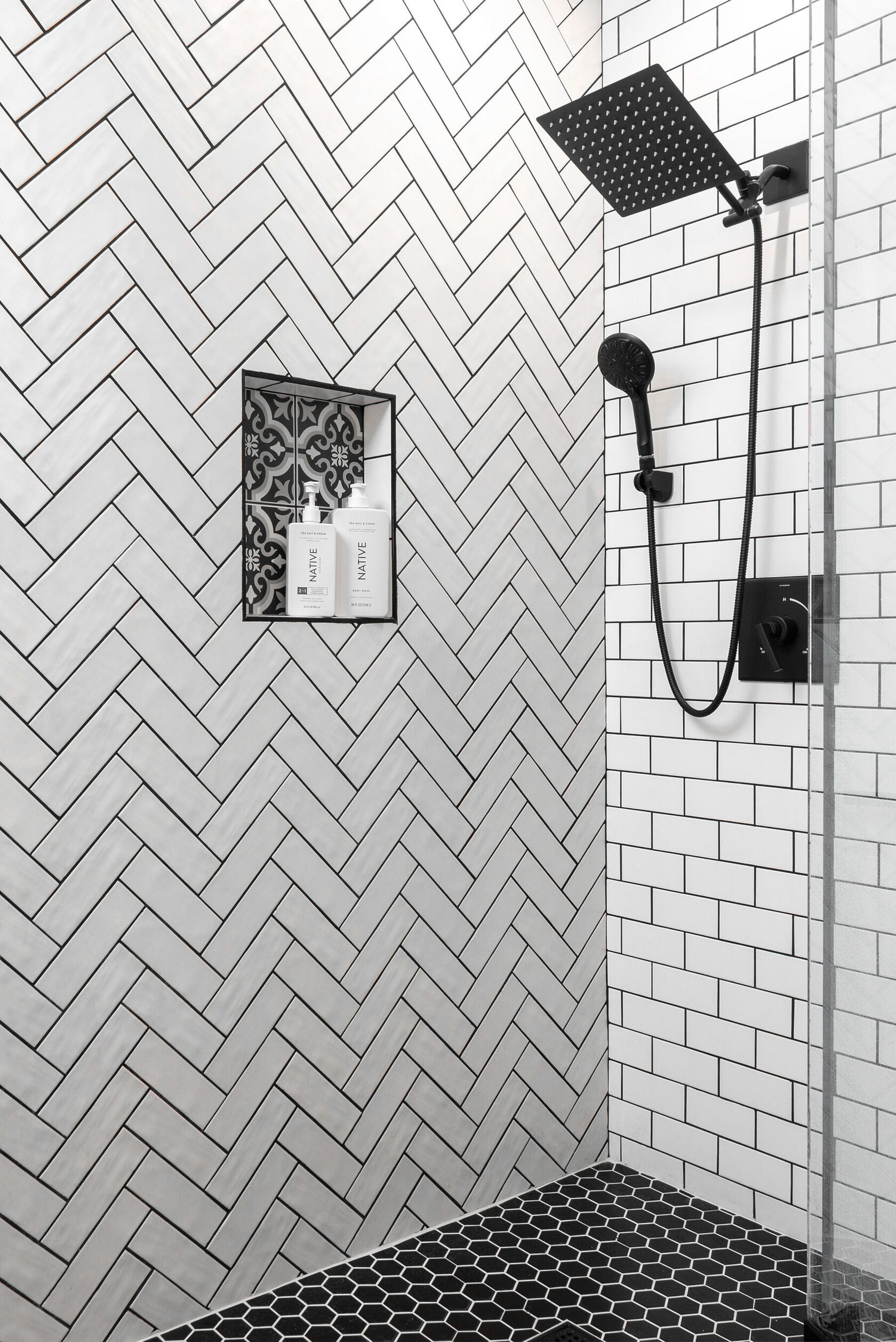 Primary bath walk-in shower, herringbone tile, black rain head