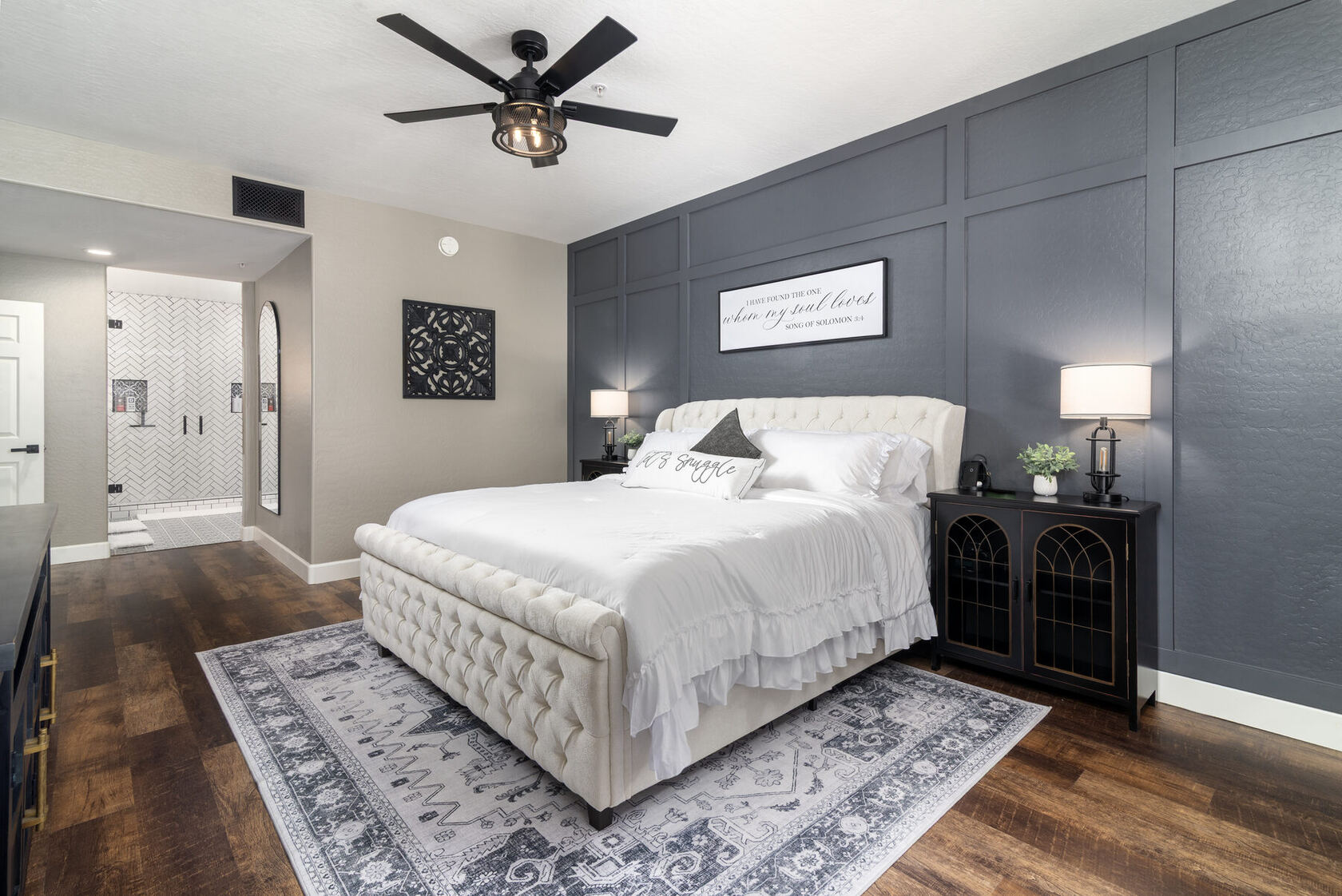 Primary suite with king bed and dark feature wall
